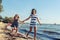 Happy carefree family running on beach at sea.