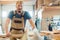 Happy carpenter in his wood workshop