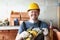 Happy carpenter worker with professional sander machine get ready to work