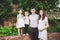 Happy caucasian big family posing in the yard of a house in summer. Pregnant woman with two heterosexual children and father of