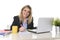 Happy Caucasian blond business woman working on laptop computer at modern office desk