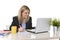 Happy Caucasian blond business woman working on laptop computer at modern office desk