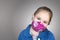 Happy caucasian blonde girl portrait wearing a protective face mask. Empty copy space.