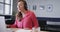 Happy caucasian casual businesswoman making video call using laptop at desk, slow motion