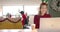 Happy caucasian casual businesswoman with reindeer hat making video call at christmas, slow motion