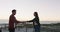 Happy caucasian couple dancing on the beach by the sea