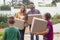 Happy Caucasian family holding cardboard boxes in home yard