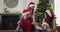 Happy caucasian family wearing santa hats sharing with presents