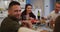 Happy caucasian father smiling to camera at table during family meal