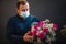 Happy caucasian florist making bouquets of red and pink roses for valentine\'s day.