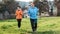 Happy caucasian grandmother and granddaughter running together. Old and young women in sports clothes, jogging in the