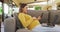 Happy caucasian pregnant woman sitting in armchair and using smartphone and laptop