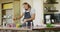 Happy caucasian pregnant woman wearing apron, cooking and making call