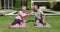 Happy caucasian senior couple exercising practicing yoga in garden in the sun high fiving