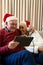 Happy caucasian senior couple having christmas tablet video call embracing at home, copy space