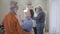 Happy Caucasian senior man and woman dancing in nursing home. Lonely elderly retiree dance with volunteer at the