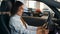 Happy Caucasian successful businesswoman joyful woman sit in new car in automobile shop rent service dealership decide