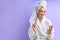Happy caucasian woman in bathrobe trims nails