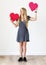 Happy Caucasian woman holding red hearts love