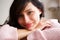 Happy caucasian woman leaning on table at home