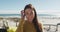 Happy caucasian woman standing near beach buggy by the sea