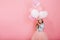 Happy celebration of birthday party with flying balloons charming cute little girl in tulle skirt smiling to camera