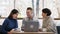 Happy and charismatic group of friends multiracial meeting at the coffee shop two ladies and one guy they using a laptop