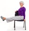 Happy charming beautiful elderly woman doing exercises at home on a chair. Workout gymnastics for health. On a white background