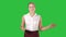 Happy charming european woman smiling broadly at camera and talking on a green screen, chroma key.