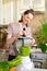 happy and cheerful caucasian woman in a t-shirt in her kitchen makes a green smoothie