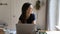 Happy cheerful freelance employee sitting at laptop in home office