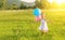 Happy cheerful girl playing and having fun with balloons in the summer