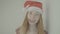 Happy cheerful girl in red santa claus, color profile Slog3