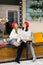 Happy and cheerful girlfriends in red berets drink coffee at the table of the street cafe. A strong friendship between two young w