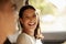 Happy, cheerful and laughing woman enjoying a road trip, holiday or vacation with her boyfriend in the car. Latino woman