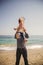 Happy cheerful loving family, father and little daughter playing on beach, young father is throwing his kid up