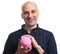 Happy cheerful man holds a pink piggy bank.