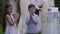 Happy cheerful Middle Eastern children clapping smiling looking at camera with unrecognizable couple getting married at