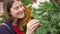 Happy cheerful woman buying Christmas decorations in mall. Female choosing faux Christmas tree