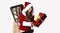 Happy cheerful woman in red Santa Claus outfit coming out of a smartphone. Christmas concept