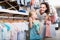 Happy cheerful woman with small child choosing clothes