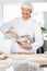 Happy Chef Mixing Batter In Bowl To Prepare