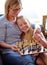 Happy, chess and a mother and child with a game for competition, strategy or thinking. Smile, family and a mom, girl or