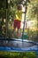 Happy child, active boy plays outdoors in playground jumping high on trampoline