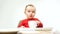 Happy child baby girl toddler sitting with keyboard of computer isolated on a white background