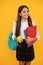 happy child with backpack and workbooks hold apple lunch in school uniform, september.