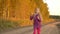 Happy child blowing soap bubbles outdoors. Young girl at country road. Golden autumn. Slow motion