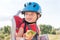 Happy child (boy) is eating lunch (snack) during bicycle ride.