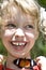 Happy child with butterfly on neck.