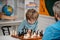 Happy child and childhood. Kid Playing Chess. Intelligent, smart ass kids. Games good for brain intelligence concept.